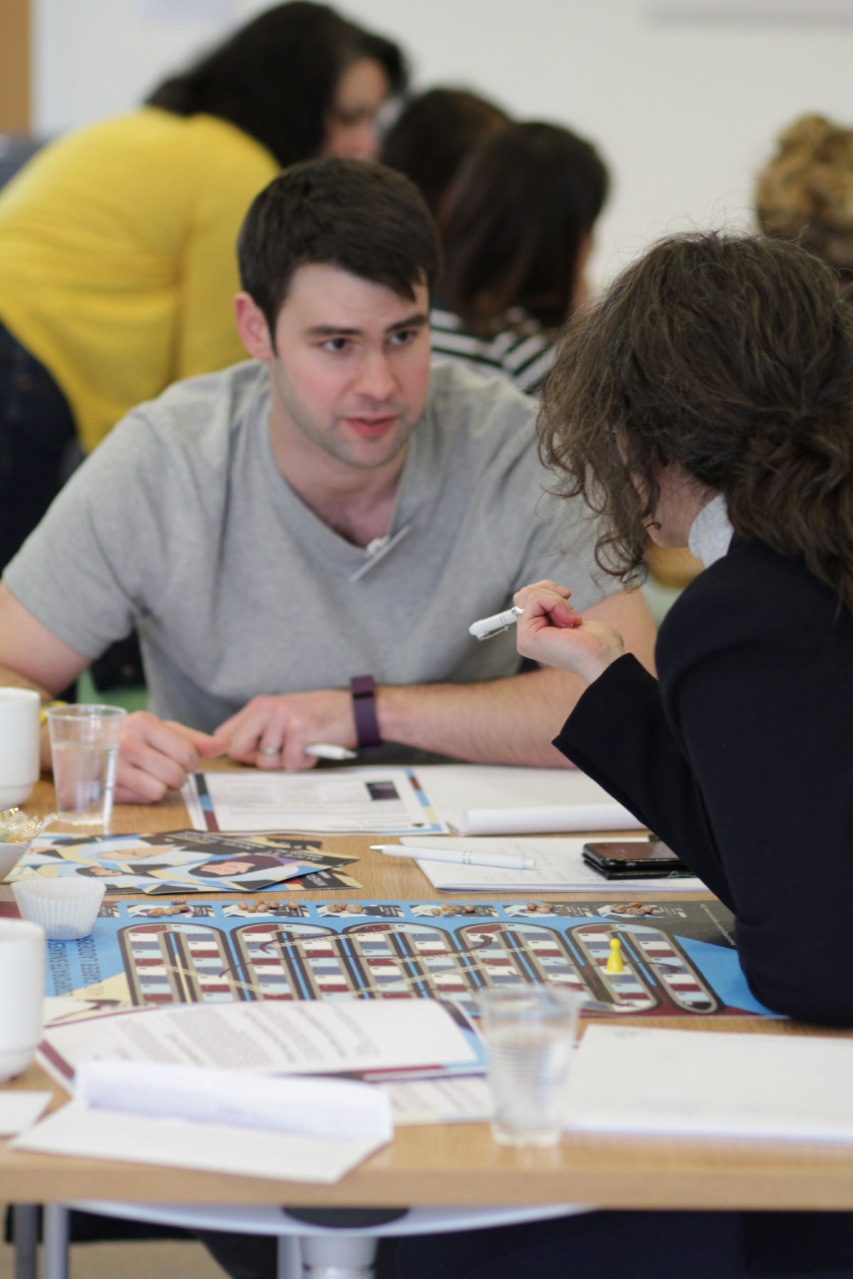 Image of two people playing the Corporate Snakes & Career Ladders game